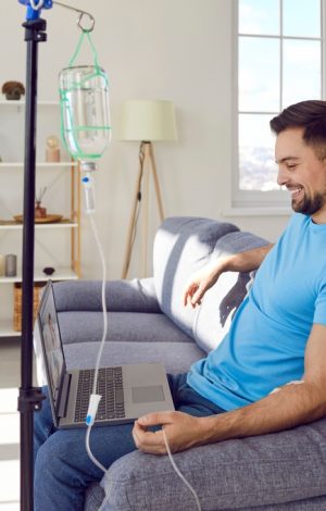 Young,Man,Sitting,On,Sofa,And,Having,Online,Video,Call